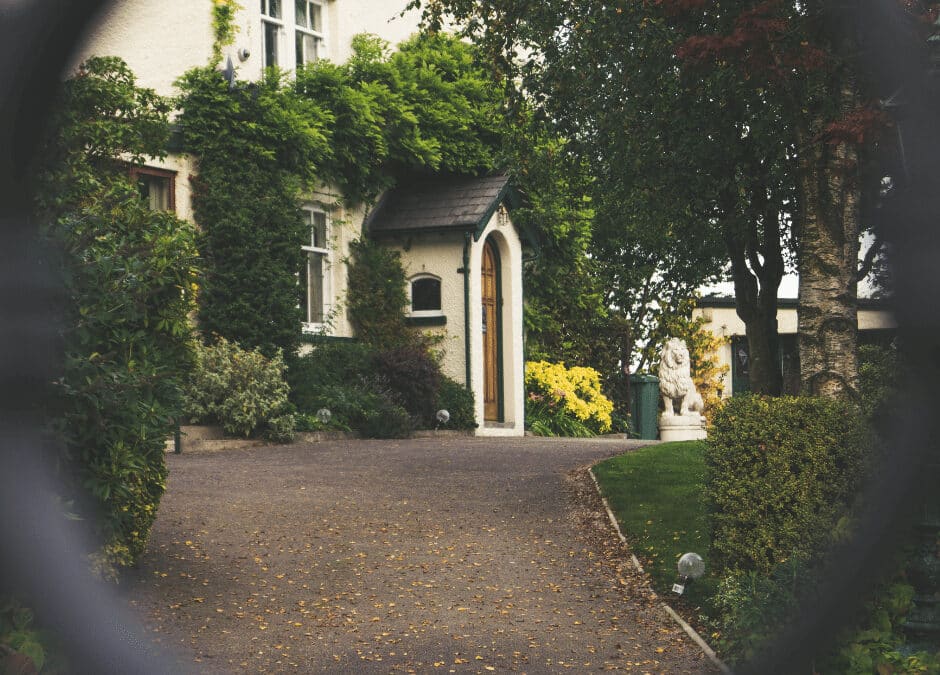 Driveway and house seen through a blurred gate