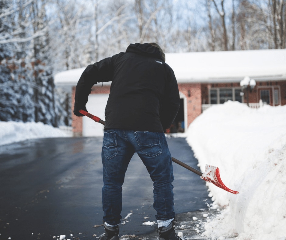 A man clearing snow for driveway maintenance